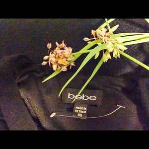 Bebe form fitting dress with a crisscross back.